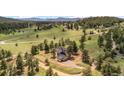Panoramic aerial view showcasing a home nestled in a lush, green landscape with mountain views at 25350 Ridge Way, Golden, CO 80401