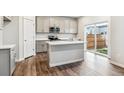 Bright kitchen with white cabinets, an island, and stainless appliances, perfect for cooking and gathering with loved ones at 1399 Orchard St, Brighton, CO 80601