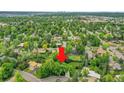 Aerial view of a lush, green residential area, showing the property's location amongst mature trees at 595 W Lake Ave, Littleton, CO 80120