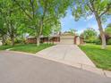 Brick single-Gathering home with an attached garage, spacious driveway and a well-maintained lawn at 595 W Lake Ave, Littleton, CO 80120