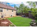 A fenced backyard offering a lush lawn and outdoor seating, perfect for relaxation and entertaining at 2507 9Th St, Boulder, CO 80304
