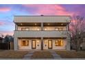 Modern two-story home featuring a flat roof design and private balconies at 2538 S Acoma St, Denver, CO 80223