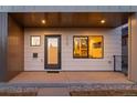 Inviting front porch with modern door, stylish exterior details, and ample natural light at 2538 S Acoma St, Denver, CO 80223