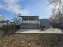 Backyard patio with deck, lawn, and parking at 4247 S Pitkin St, Aurora, CO 80013