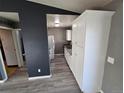 Galley kitchen with stainless appliances, gray counters, and white cabinets at 4247 S Pitkin St, Aurora, CO 80013