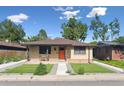Quaint home featuring fresh landscaping and a welcoming front entrance at 1112-1112 1/2 Krameria St, Denver, CO 80220