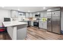 Modern kitchen boasts stainless steel appliances and gray cabinetry at 1112-1112 1/2 Krameria St, Denver, CO 80220