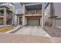Exterior view of a gray three-story townhouse with a front-facing two car garage at 15794 W Girard Ave, Morrison, CO 80465