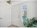 Clean entryway with natural light from sidelight, showcasing a light-colored floor and access to rooms at 4108 N Quatar Ct, Aurora, CO 80019