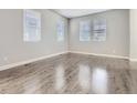 Bright, airy bedroom with hardwood floors and three large windows providing ample natural light at 4773 Kittredge St, Denver, CO 80239