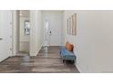 Inviting entryway with wood flooring, a bench, and a view into other rooms at 757 Cabot Dr, Erie, CO 80516