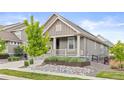Charming home with a covered porch and rock garden at 757 Cabot Dr, Erie, CO 80516