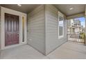 Covered front porch featuring a modern front door and ample space at 757 Cabot Dr, Erie, CO 80516
