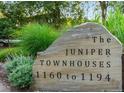 Elegant stone sign identifying 'The Juniper Townhouses' with address range at 1172 Juniper Ave, Boulder, CO 80304