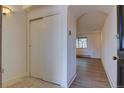 Bright entryway with tile floor and closet, leading into a living space with wood floors at 1172 Juniper Ave, Boulder, CO 80304