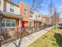 Well-maintained row of townhomes with front patios and landscaped yards along sidewalk at 7323 Lowell Blvd, Westminster, CO 80030