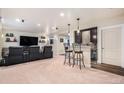 Basement theater featuring leather recliners and built in bar at 13326 Olive Way, Thornton, CO 80602