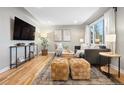 Inviting living room with hardwood floors, large window, and comfortable seating area at 5231 Quitman St, Denver, CO 80212