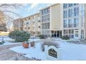 Building exterior showcasing landscaping and snow at 13626 E Bates Ave # 207, Aurora, CO 80014