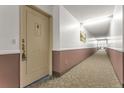 Clean hallway with neutral walls and carpet at 13626 E Bates Ave # 207, Aurora, CO 80014