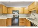 Bright kitchen featuring plenty of cabinet space, modern countertops and appliances at 13626 E Bates Ave # 207, Aurora, CO 80014