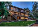 Backyard view featuring a spacious deck, hot tub, and well-maintained lawn at 9658 Coronado Ct, Parker, CO 80134