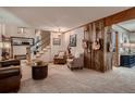 Inviting living room features a rustic wood accent wall and a staircase at 9658 Coronado Ct, Parker, CO 80134