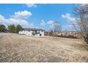 Back of the house showing a large backyard and patio at 6714 Depew St, Arvada, CO 80003