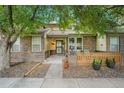 Charming brick home featuring a well-kept front yard, fence and inviting front porch at 9193 W 7Th Ave, Lakewood, CO 80215