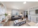 Elegant living room with modern decor, large window, and a seamless transition to the dining area at 1476 W Dakota Ave, Denver, CO 80223