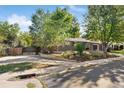 Brick house with landscaped yard, privacy fence, and basketball hoop at 2432 S Newport St, Denver, CO 80224