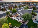 Aerial view of a home with a spacious backyard, patio, and lush landscaping at 3107 S Nepal Way, Aurora, CO 80013