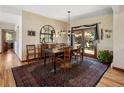 Dining room with a wooden table, decorative rug, and a large window offering natural light at 107 Elk Dr, Evergreen, CO 80439