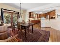 Dining room with wood table, a vintage rug, and sliding doors to the backyard at 107 Elk Dr, Evergreen, CO 80439