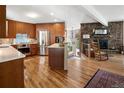 Open concept kitchen with wooden cabinetry, stainless steel appliances, and hardwood floors at 107 Elk Dr, Evergreen, CO 80439