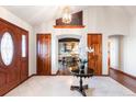 Elegant foyer featuring tile floors, white walls, and decorative doorway to dining room at 8187 N Pinewood Dr, Castle Rock, CO 80108