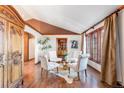 Cozy sitting room with hardwood floors, a decorative armoire, and comfortable furnishings at 8187 N Pinewood Dr, Castle Rock, CO 80108