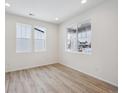 Bright living room with hardwood floors and large windows at 811 Goodrich Peak St, Erie, CO 80516