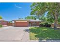 Charming single-story brick home with a well-maintained lawn and mature landscaping at 1774 S Dover Way, Lakewood, CO 80232