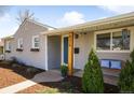 Detailed view of home's architectural details, including the porch and well-kept yard at 4374 S Washington St, Englewood, CO 80113