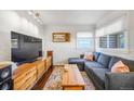 Bright living room with a plush sectional couch, stylish coffee table, and ample natural light at 4374 S Washington St, Englewood, CO 80113