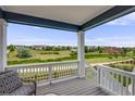 Relaxing covered porch with scenic views of the green neighborhood and walking paths in a quiet setting at 10387 Harrisburg St, Parker, CO 80134