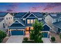 Beautiful two-story navy blue home showcasing a three-car garage and solar panels at 10387 Harrisburg St, Parker, CO 80134