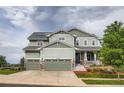 Lovely two-story home with a two-car garage, covered front porch, and beautifully landscaped front yard at 23503 E Minnow Dr, Aurora, CO 80016