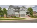 Attractive two-story home with a two-car garage, solar panels, inviting porch, and well-maintained landscaping at 23503 E Minnow Dr, Aurora, CO 80016
