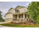 This two-story home features a covered porch, tasteful landscaping, and an attached two-car garage at 23503 E Minnow Dr, Aurora, CO 80016