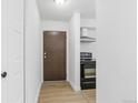 Compact kitchen featuring white cabinets and black appliances, offering functionality in a modern design at 7755 E Quincy Ave # 107D2, Denver, CO 80237