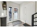 Bright entryway featuring wood-look flooring, a white door with glass, and a view of the outside at 5531 W 11Th Pl, Lakewood, CO 80214