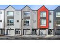 Modern townhomes with gray siding and a pop of color showcasing unique architectural design at 5531 W 11Th Pl, Lakewood, CO 80214