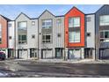 Modern row of townhomes with attached garages, featuring contemporary exteriors and inviting entrances at 5531 W 11Th Pl, Lakewood, CO 80214